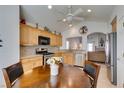 Eat-in kitchen with stainless steel appliances, wood cabinetry, and a view to the living room at 6 Sandwedge Dr, Henderson, NV 89074