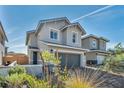 Two-story home with a charming front yard, a two car garage and a beautifully landscaped driveway at 688 Monroe Hill Pl, Henderson, NV 89011