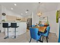 View of the dining area leading to the kitchen, with counter seating and stainless steel appliances at 701 Wheat Ridge Ln # 203, Las Vegas, NV 89145