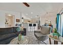 Open-concept living area with neutral tones, kitchen bar, and comfortable seating at 701 Wheat Ridge Ln # 203, Las Vegas, NV 89145
