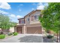 Charming two-story home featuring a finished two car garage, desert landscaping and a welcoming facade at 7300 Lavender Rose Ave, Las Vegas, NV 89117