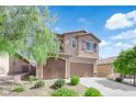 Charming two-story home featuring a finished two car garage, desert landscaping and a welcoming facade at 7300 Lavender Rose Ave, Las Vegas, NV 89117