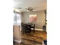 Well-lit dining area featuring modern ceiling fan and wood-look flooring at 779 Peregrine Falcon St, Henderson, NV 89015