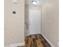 Inviting entryway with wood-look flooring and a classic white front door at 779 Peregrine Falcon St, Henderson, NV 89015
