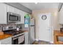 Well-equipped kitchen features stainless steel appliances and warm wood countertops at 779 Peregrine Falcon St, Henderson, NV 89015