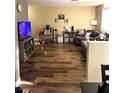Spacious living room with wood-look flooring and cozy seating at 779 Peregrine Falcon St, Henderson, NV 89015
