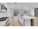 Modern kitchen featuring a large island, stainless steel appliances, and white cabinetry at 8043 Tank Loop St, Las Vegas, NV 89166