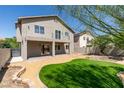 Home backyard includes manicured lawn, patio, landscaping, and privacy fence at 8108 Artistic Heights Ct, Las Vegas, NV 89143