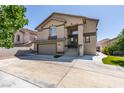 Two-story home with neutral stucco, a columned porch, and a two car garage at 8108 Artistic Heights Ct, Las Vegas, NV 89143
