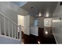 Bright entryway featuring wood floors, open floor plan, and stairs to the second level at 8218 Golden Flowers St, Las Vegas, NV 89139