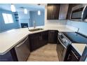 Kitchen featuring stainless appliances, wood-look flooring, and white countertops at 8600 W Charleston Blvd # 2068, Las Vegas, NV 89117