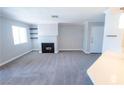 Spacious living room with black fireplace, shelving, and natural light from a window at 8600 W Charleston Blvd # 2068, Las Vegas, NV 89117