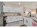Bright kitchen featuring granite countertops, stainless appliances, and sleek white cabinetry at 8737 Red Brook Dr # 201, Las Vegas, NV 89128