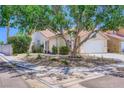Inviting single-story home with a well-maintained front yard, desert landscaping, and attached two car garage at 8934 Libertyvale Dr, Las Vegas, NV 89123
