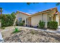 Well-maintained home with desert landscaping and mature shrubbery with an attached garage and inviting entrance at 8934 Libertyvale Dr, Las Vegas, NV 89123