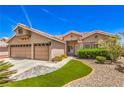 Inviting home with a well-manicured lawn and a spacious three-car garage at 1044 Spanish Needle St, Henderson, NV 89002