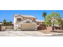 View of the front of a two-story home featuring a two-car garage and low-maintenance desert landscaping at 1073 Nordyke Ave, Henderson, NV 89015