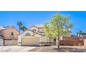 Two-story home featuring a neutral stucco exterior, desert landscaping, and an attached two-car garage at 1073 Nordyke Ave, Henderson, NV 89015