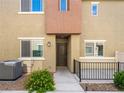 Exterior view of a townhome featuring a private entry and landscaping at 12112 Polar White Ct # 3, Las Vegas, NV 89183