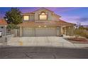 Stunning exterior view of a two-story home with a three-car garage and well manicured front yard at 2021 Summit Pointe Dr, Las Vegas, NV 89117