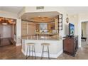 Stylish kitchen with granite countertops and barstool seating adjacent to living area at 222 Karen Ave # 3208, Las Vegas, NV 89109