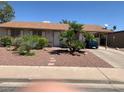 Single Gathering home with mature palm trees and carport over the driveway at 225 Dogwood St, Henderson, NV 89015