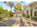 Spacious three-car garage with lush landscaping and ample driveway space for parking at 2346 Villandry Ct, Henderson, NV 89074