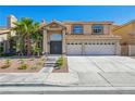 Inviting two-story home with arched windows, a tile roof and an attached two-car garage at 2409 Alpine Meadows Ave, Henderson, NV 89074