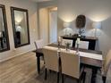 Elegant dining room with a wooden table set for six, complemented by stylish decor and neutral tones at 242 Homeward Way, Henderson, NV 89011