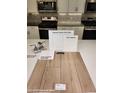 Kitchen finish selection featuring stainless faucet, white shaker cabinets, and wood laminate flooring at 2776 Via Napoli, Henderson, NV 89044