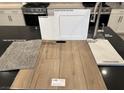 Kitchen finish selection featuring stainless faucet, white shaker cabinets, and wood laminate flooring at 2776 Via Napoli, Henderson, NV 89044