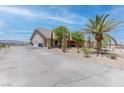 Long private driveway with desert landscaping leading up to a well-maintained home at 2780 Avenue Of The Stars, Pahrump, NV 89060