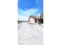 Spacious home exterior featuring a long driveway, desert landscaping, and mountain views at 2780 Avenue Of The Stars, Pahrump, NV 89060