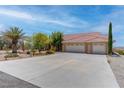 Expansive driveway leading to a three-car garage with a well-maintained desert landscape at 2780 Avenue Of The Stars, Pahrump, NV 89060