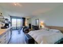 Living room featuring wood floors, bed, furniture, and sliding glass door at 29 Montelago Blvd # 209, Henderson, NV 89011