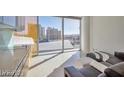 Bright living room with a contemporary sofa and city views from floor-to-ceiling windows at 3722 Las Vegas Blvd # 603, Las Vegas, NV 89158
