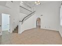 Spacious living room with staircase, tile floors, and bright, natural light at 3935 Tirana Way, Las Vegas, NV 89103