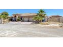 Picturesque home with block wall, metal gate and mature landscaping, circular driveway and desert landscaping at 4011 Scott Russell Ct, North Las Vegas, NV 89031