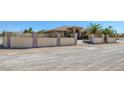 Attractive property features a walled gate with metal detailing, desert landscaping and privacy at 4011 Scott Russell Ct, North Las Vegas, NV 89031
