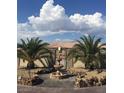 Beautiful front yard featuring palm trees, rock landscaping, and a decorative fountain, enhancing curb appeal at 4011 Scott Russell Ct, North Las Vegas, NV 89031