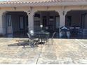 Covered patio with ample seating, grill, and sleek concrete flooring, perfect for outdoor entertaining and relaxation at 4011 Scott Russell Ct, North Las Vegas, NV 89031