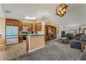 Open-concept floorplan showing the kitchen, living room and dining nook at 420 Aloha Dr, Henderson, NV 89015
