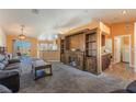 Open-concept living room with a large built-in entertainment center, and a back patio at 420 Aloha Dr, Henderson, NV 89015
