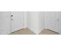 Bright entryway featuring wood-look floors and multiple doors at 4450 E Brusca Ct, Pahrump, NV 89061