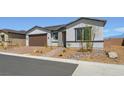 Attractive one-story home features desert landscaping and a brick paved driveway at 4450 E Brusca Ct, Pahrump, NV 89061