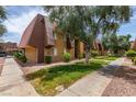 View of building with mature trees, bushes, well manicured lawn and sidewalks at 5240 Indian River Dr # 273, Las Vegas, NV 89103