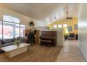 Bright living room featuring wood-look floors, comfortable seating, and natural light at 6242 Halehaven Dr, Las Vegas, NV 89110