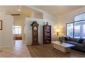 Open living area boasting tile and wood-look floors, large windows, and neutral decor at 6242 Halehaven Dr, Las Vegas, NV 89110