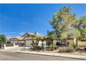 Charming home featuring desert landscaping and an attached two-car garage at 6521 Faith Peak Dr, Las Vegas, NV 89108