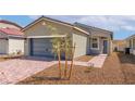 Charming single-story home featuring a two-car garage, small tree, and sidewalk at 6761 Violet Cascade Ave, Las Vegas, NV 89156